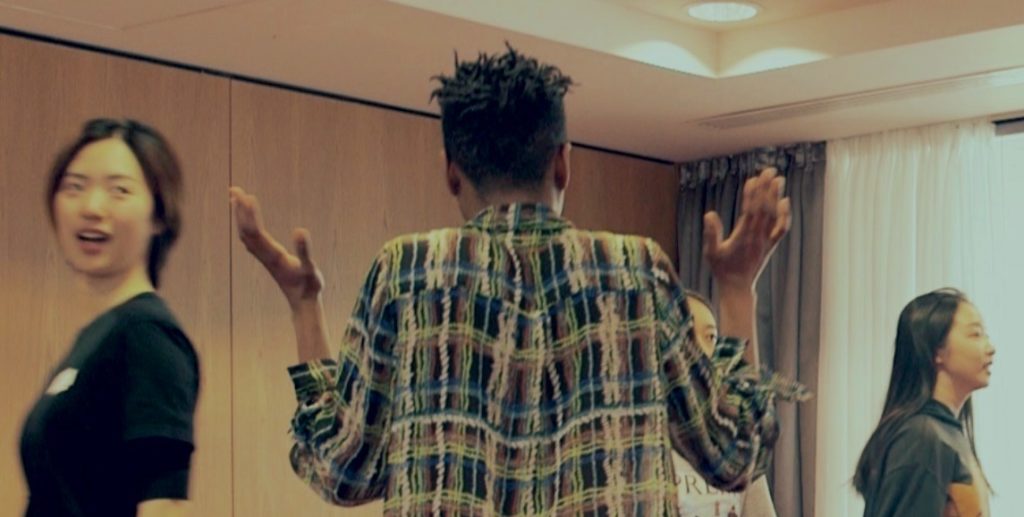 Woman shrugging from behind