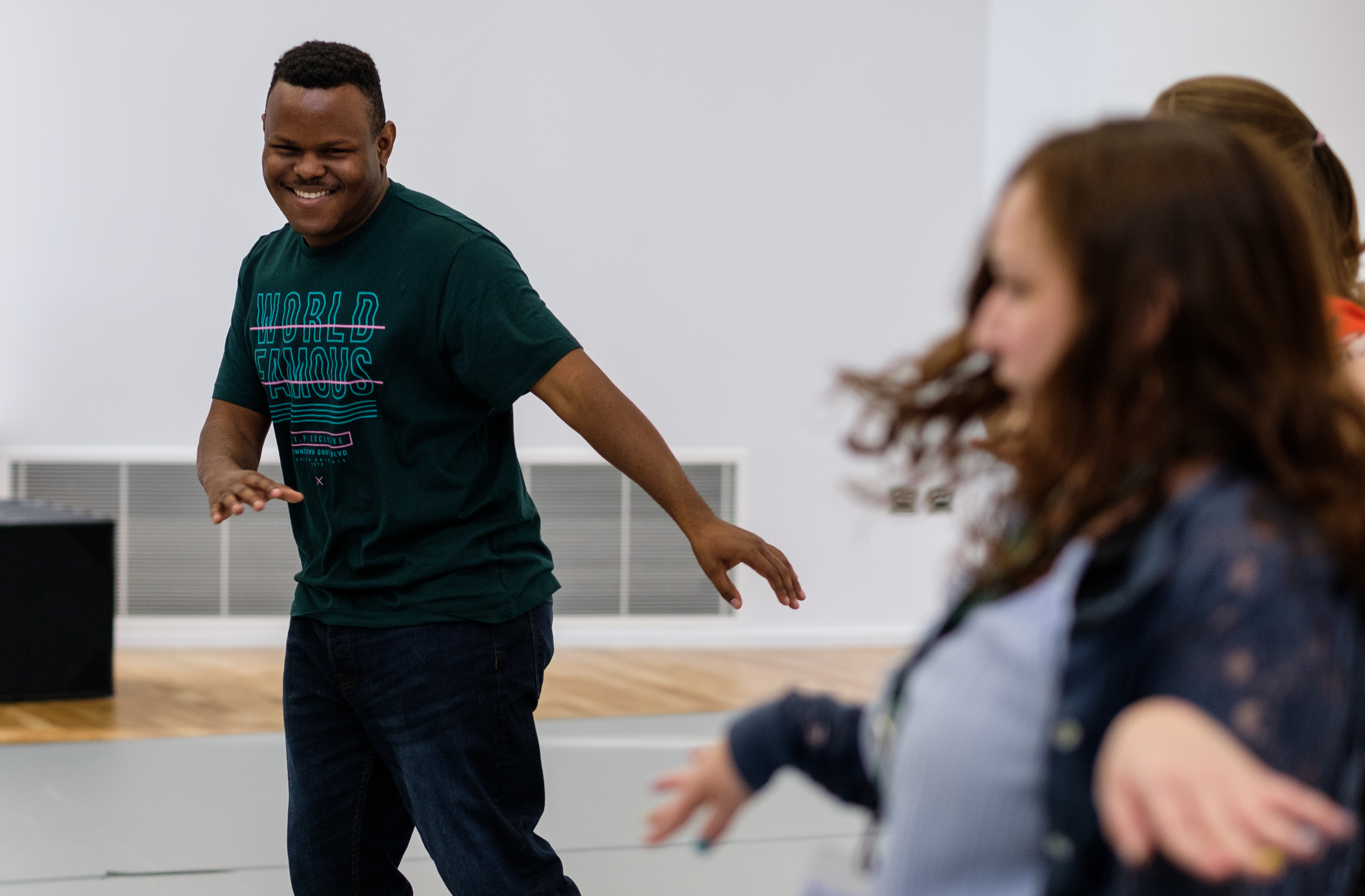 Two people dance in a drama studio